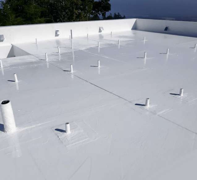 Photo of white roof with vertical pipes