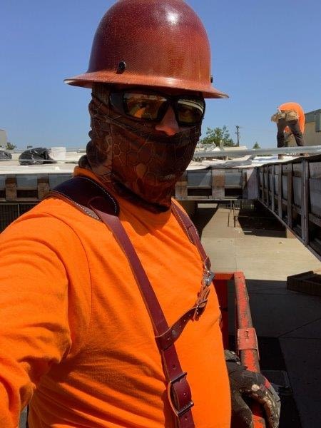Photo of Rafael Sr in orange PPE on jobsite
